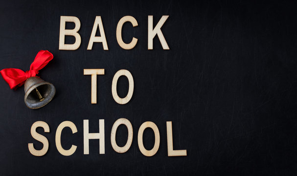 Back to school concept. Top view banner school bell over classroom blackboard background