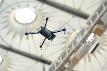 Drone hovered in air against the backdrop of stadium dome
