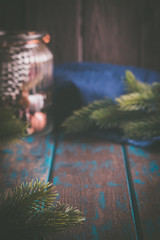 Christmas mood decoration. Rustic style Christmas. Spruce branches and wooden desk. Space for text.