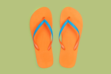 Orange Flip Flops Isolated On Green Background. Top View