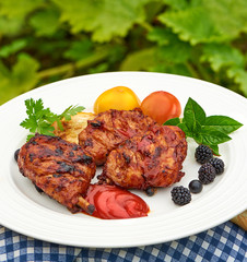 Grilled chicken Legs with spices and herbs on a plate.