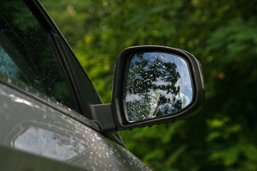 car mirror with a lot of drops of water