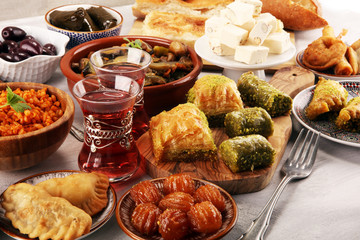 Middle eastern or arabic dishes and assorted meze, concrete rustic background. sambusak. Turkish...