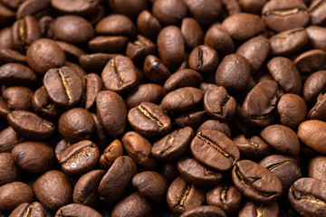Close-up roasted coffee beans background. Top view