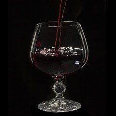Glass still life image A glass of red wine in a glass on a black background