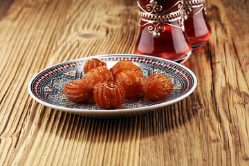 Turkish Dessert with honey on wooden table.