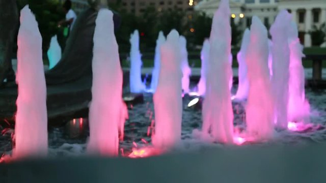 Water fountain with colorful lights at night