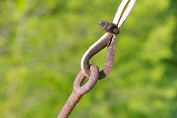 Metal links on green background