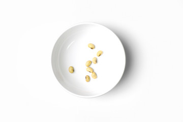 Roasted Soy in White Ceramic Bowl isolated on White Background. Top View.