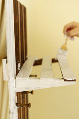 Person renovating wooden hanger