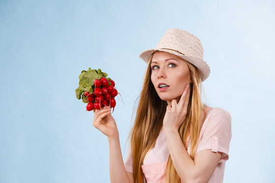 Thinking woman holding radish