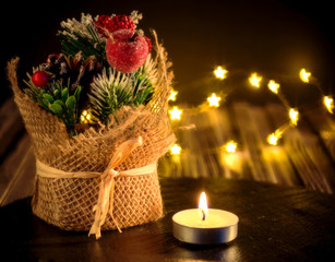 Christmas composition with Christmas tree decorations, a candle and a bokeh