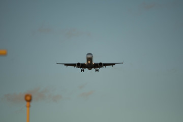 City Airport plane landing in the evening with tourists 