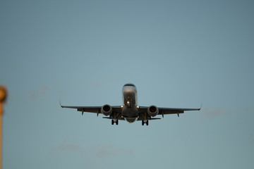 City Airport plane landing in the evening with tourists 