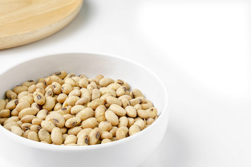 Roasted Soy in White Ceramic Bowl and Round Wood Dish isolated on White Background.
