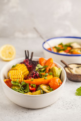 Salad with baked vegetables with tahini in white plate, white background. Clean eating concept.