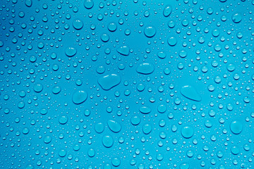 Fototapeta na wymiar Water drops on blue background, for design and advertising