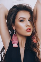 Portrait of beautiful young woman in exquisite jewelry. Fashion photo