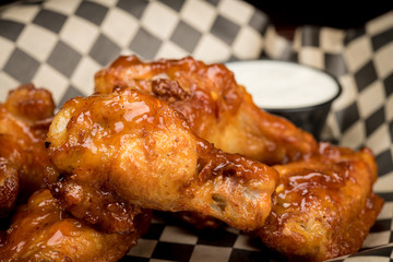 Close up of a single Chicken Wings served in a restaurant basket