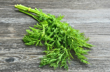 Fresh Dill on wooden background. Healthy and Benefit of Dill.