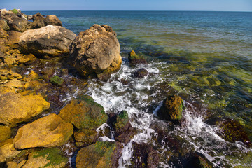 Transparent sea and stones on the shore. Landscape
