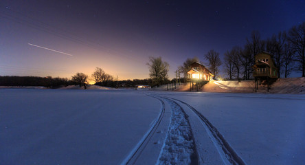 Wooden cottages in winter time, lake gateway 