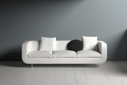 Lone white couch with square and circular pillows