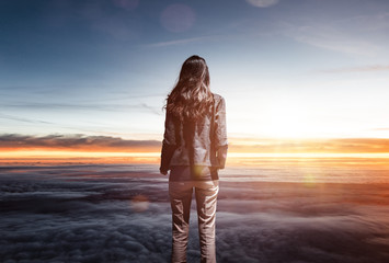 Trendy slender woman watching the sunrise