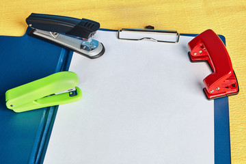 Document holder, sketch-board with hole puncher and stapler.