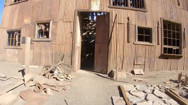 Abandoned Humberstone and Santa Laura saltpeter works factory, near Iquique, northern Chile, South America. Walking outside streets entering inside industry warehouse building.