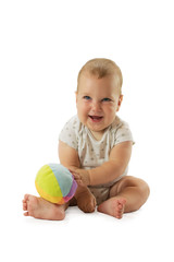 Cute happy baby boy siting on the floor and playing with fluffy ball. Isolated on white background