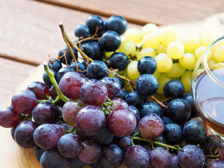 grapes and glasses on a wooden tray