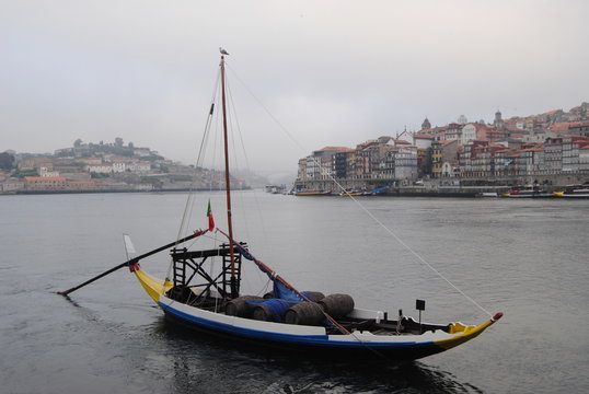 Barco rabelo com nevoeiro parado no rio d'ouro em cais de gaia de madrugada com nevoeiro