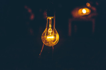 old light bulb glows in the dark close up