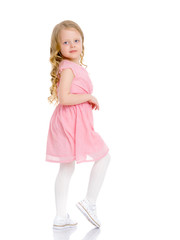 A cheerful little girl is dancing.