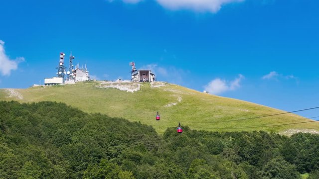 Scenic view of red cable car climbing mountain time lapse, mountain transport infrastructure
