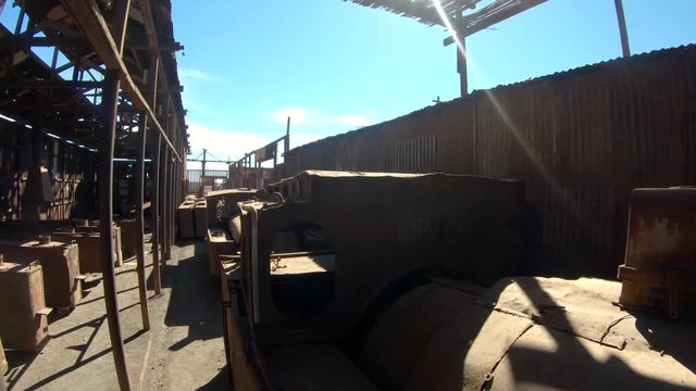 Abandoned Humberstone and Santa Laura saltpeter works factory, near Iquique, northern Chile, South America. Walking outside streets near train wagons.