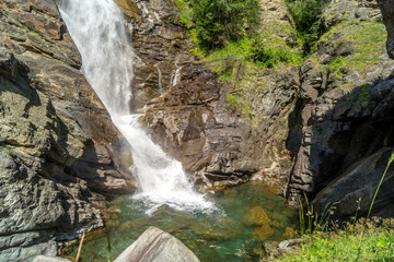 Fototapeta na wymiar waterfall in the mountains among the rocks