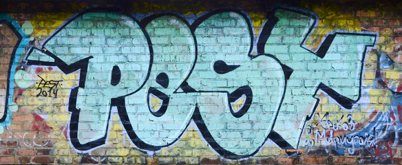 Full and acomplished graffiti artwork. The old wall decorated with paint stains in the style of street art culture. Colored background texture