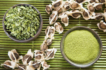 Seeds, leaves and moringa powder - Moringa oleifera. Top view