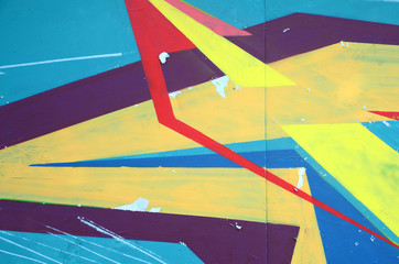 Fragment of graffiti drawings. The old wall decorated with paint stains in the style of street art...