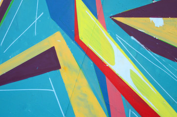 Fragment of graffiti drawings. The old wall decorated with paint stains in the style of street art...