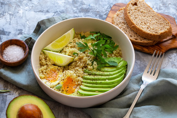 Healthy bowl with quinoa, eggs, avocado, lime and parsley. Food and health.
