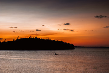 Amazing sunset on the sea. On the horizon you can see the dark outlines of the Islands in the sea