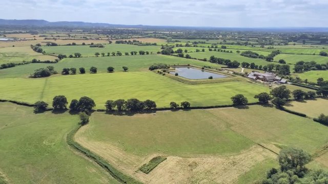 Aerial view, pan move. Drone panorama of plains and small ponds hidden between fields