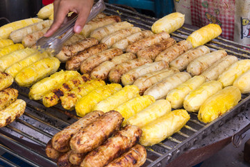 Bananas being roasted on a barbecue on a street food stall in Bangkok, Thailand