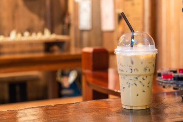 Iced coffee on a wooden table in the coffee shop.