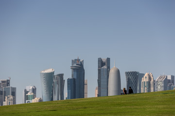 Fototapeta premium Doha, Qatar - Jan 8th 2018 - A young couple enjoy the view of the skyline of Doha's downtown in Qatar