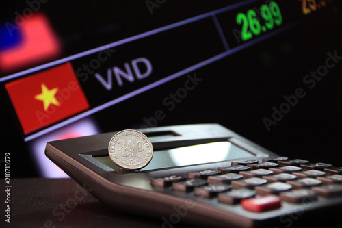 Two Hundred Vietnam Dong Coin On Reverse Vnd Black Calculator Two Hundred Vietnam Dong Coin On Reverse Vnd Black Calculator And Floor With Digital Board Of Currency Exchange Money Background The Concept