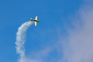Long angle view of Yak-54 in the sky performs the program at the air show - obrazy, fototapety, plakaty